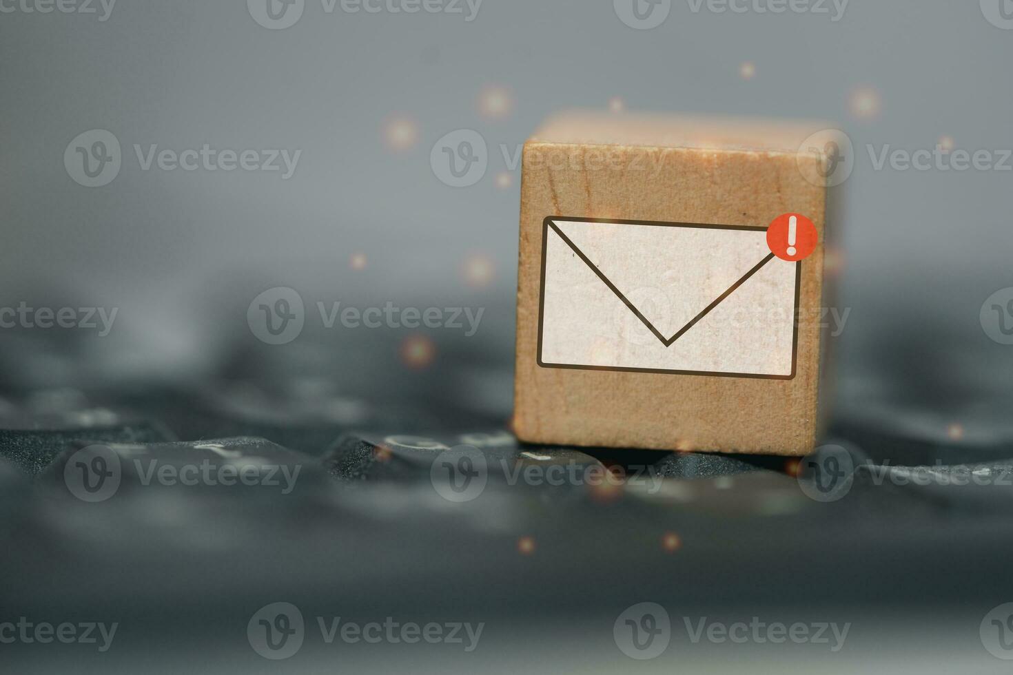 New email graphic symbol on wooden block over black computer keyboard photo