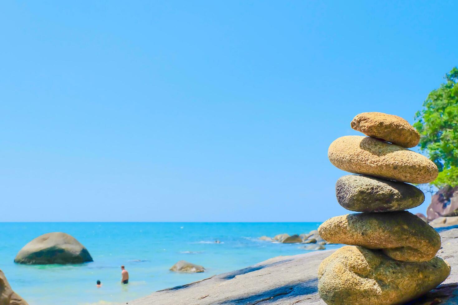 Stones pyramid and sea blue sky at Khao Lak Beach Thailand. photo