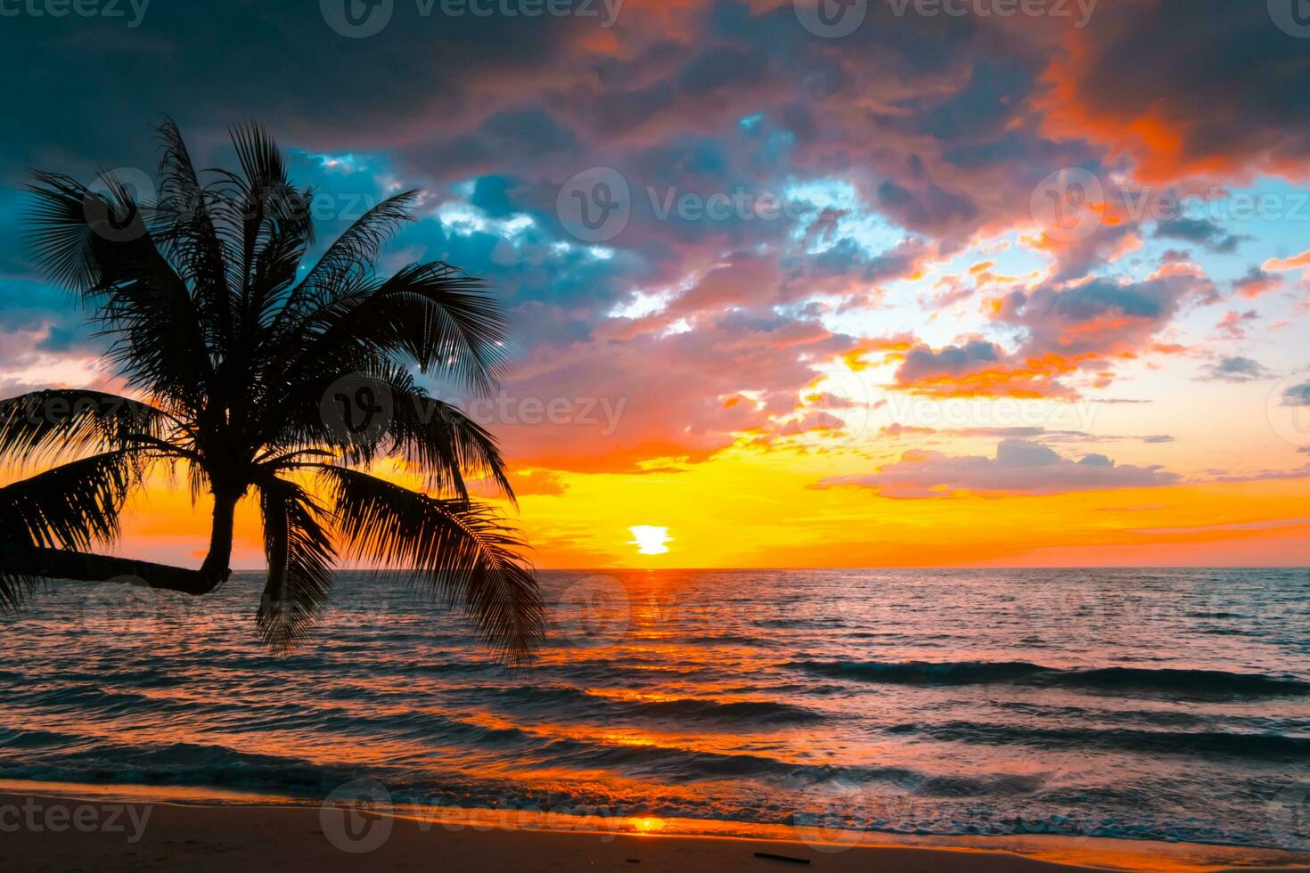 Silhouette of palm trees Beautiful sunset on the tropical sea beach background for travel in holiday relax time, photo