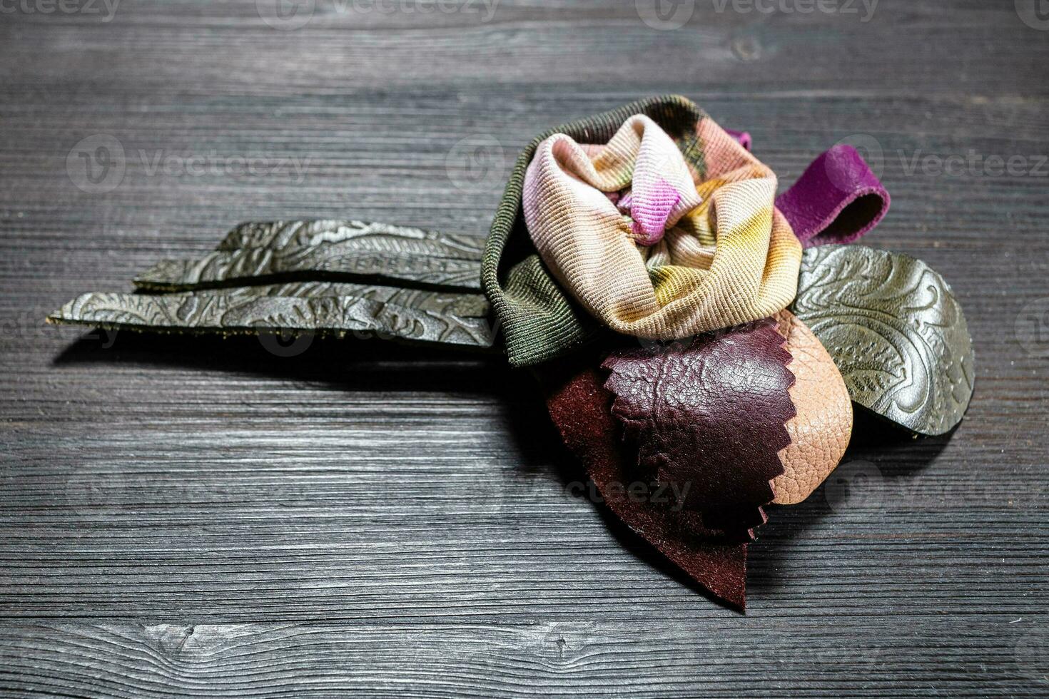 leather and silk brooch as rose flower close up photo