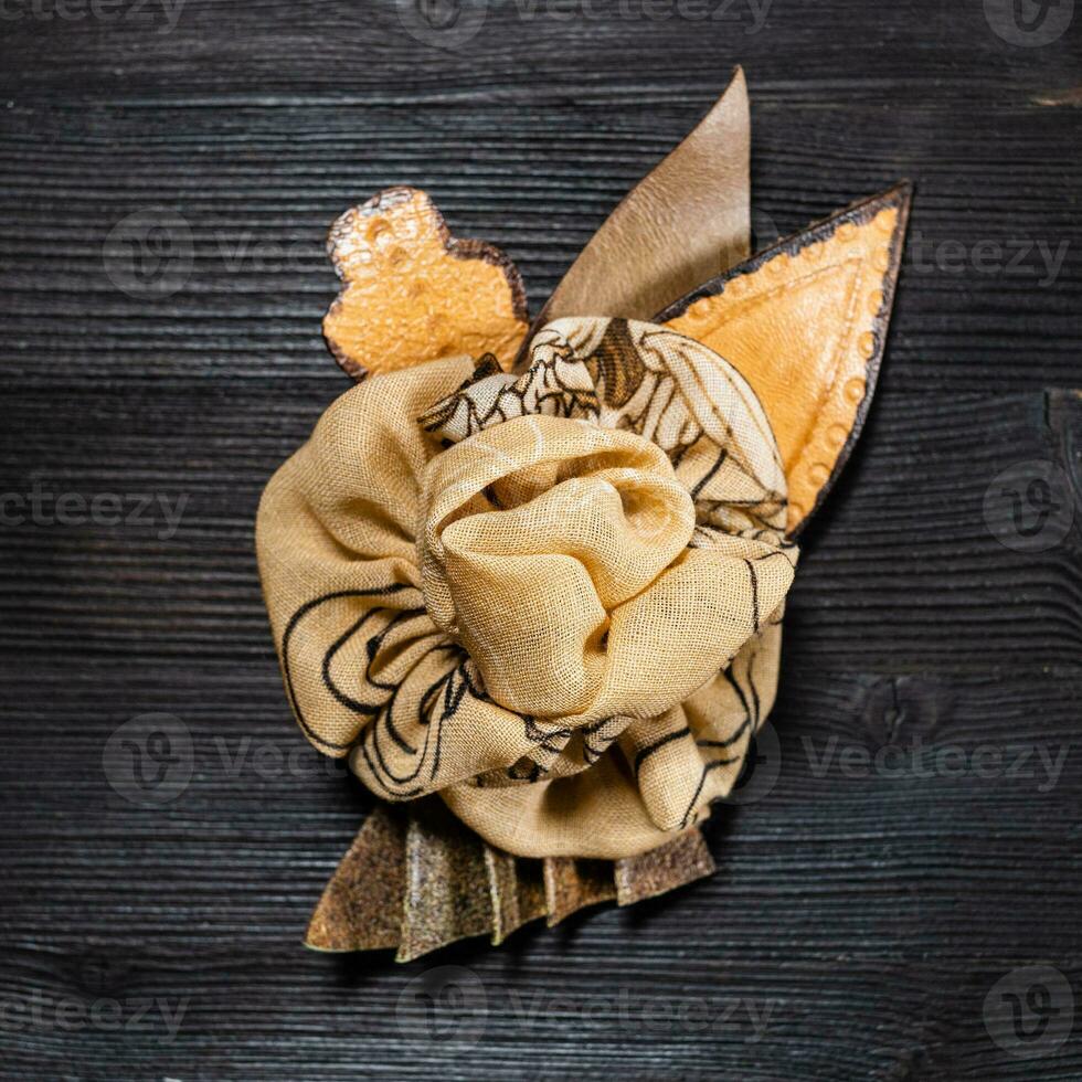 top view brown leather and silk brooch as flower photo