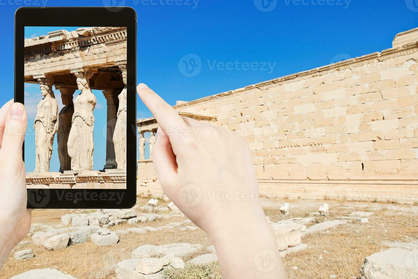 tourist taking photo of caryatids at acropolis