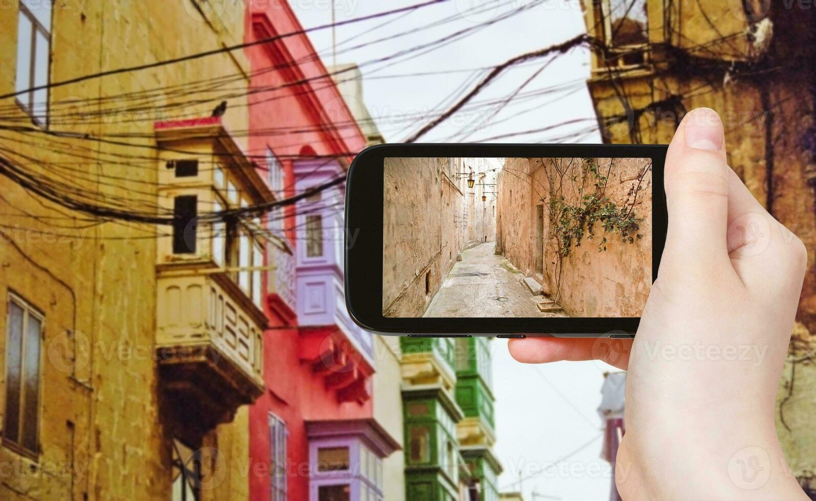 tourist taking photo of medieval narrow street