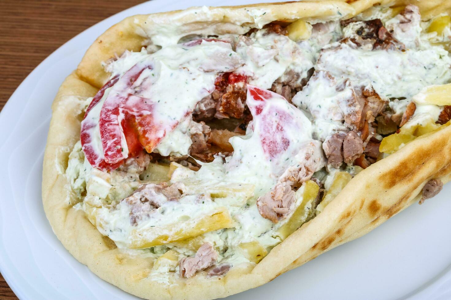 Souvlaki on the plate and wooden background photo