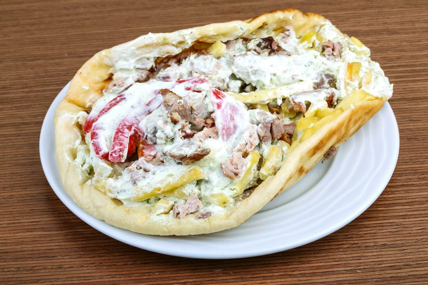 Souvlaki on the plate and wooden background photo