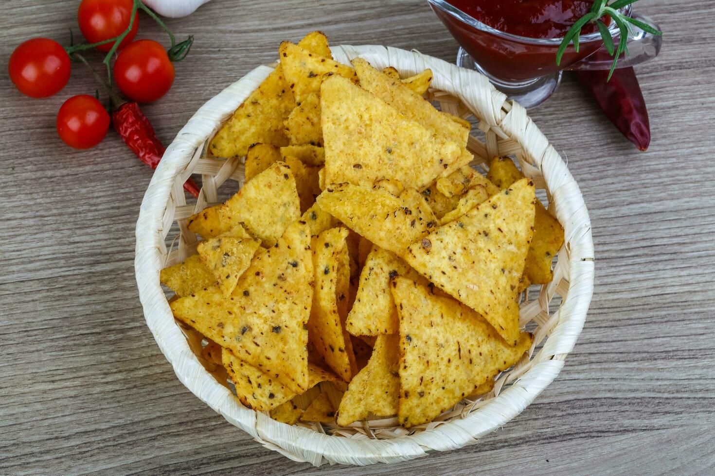 Nachos in a basket on wooden background 12861534 Stock Photo at Vecteezy