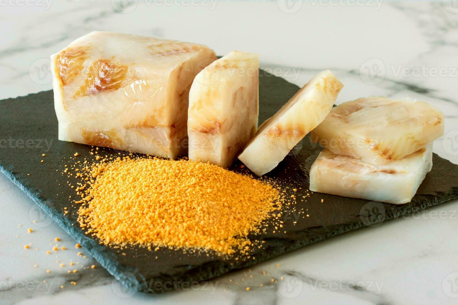 Frozen Fillet of Fish Pangasius on stone board ready for cooking. photo
