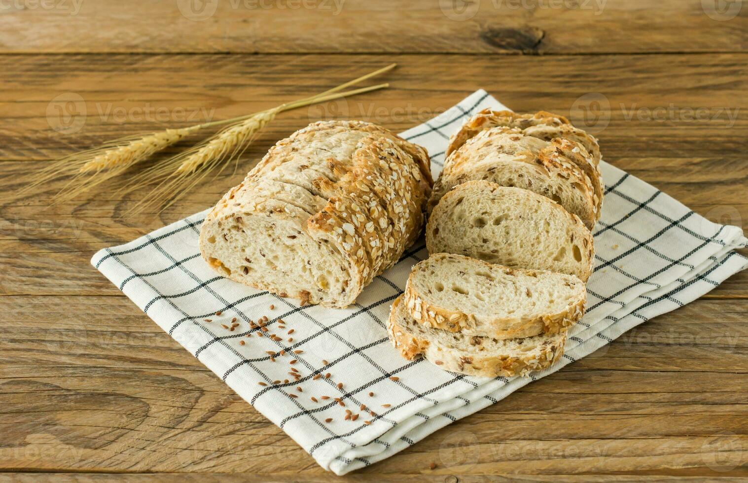 Gluten-free vegan bread and no animal products. Vegetarian bread with oatmeal, banana flavor, on a wooden rustic table, sliced and ready to serve. photo