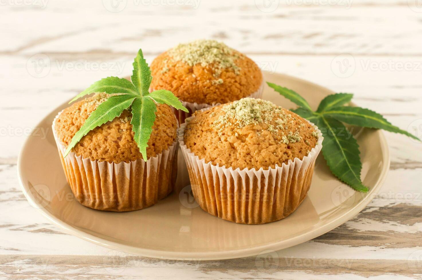 Cupcake with marijuana. Tasty cupcake muffins with cannabis weed cbd. Medical marijuana drugs in food dessert, ganja legalization. photo