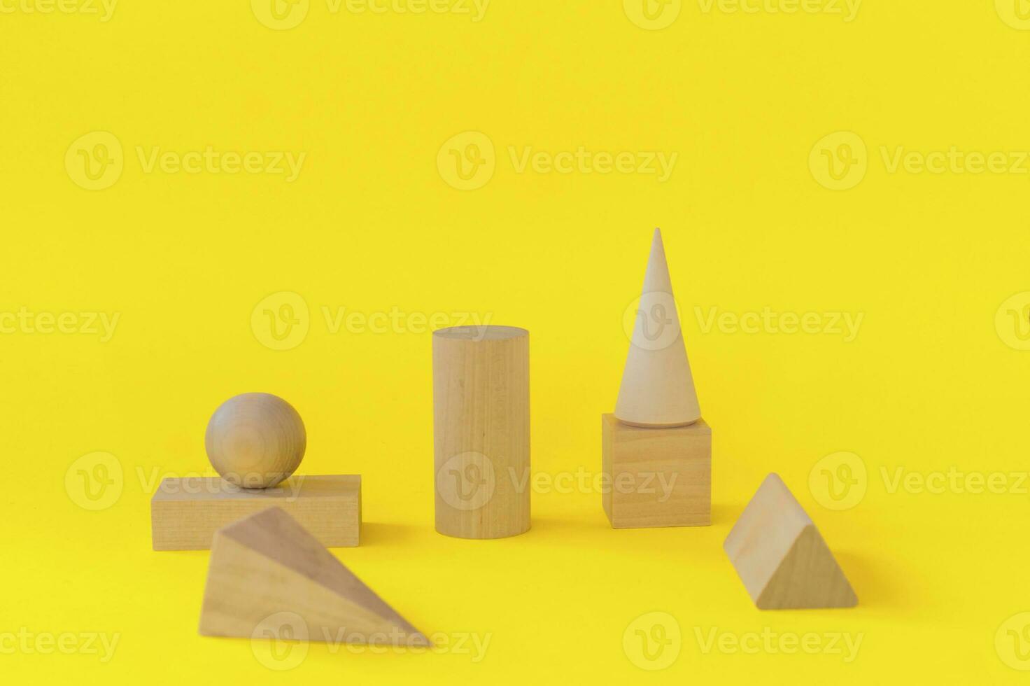 wooden geometric shapes on a yellow background. preschool learning photo