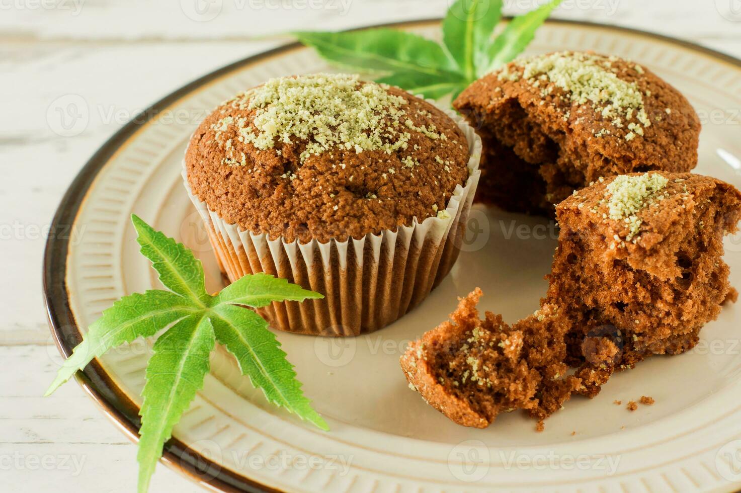 Cupcake with marijuana. Tasty cupcake muffins with cannabis weed cbd. Medical marijuana drugs in food dessert, ganja legalization. photo