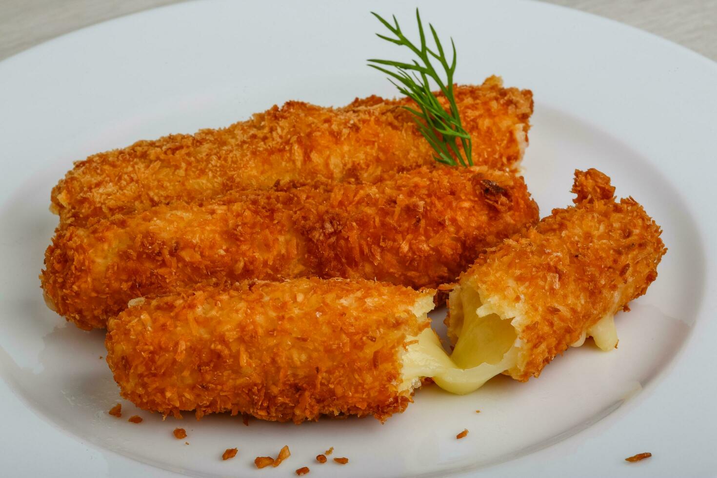 Fried cheese on the plate and wooden background photo