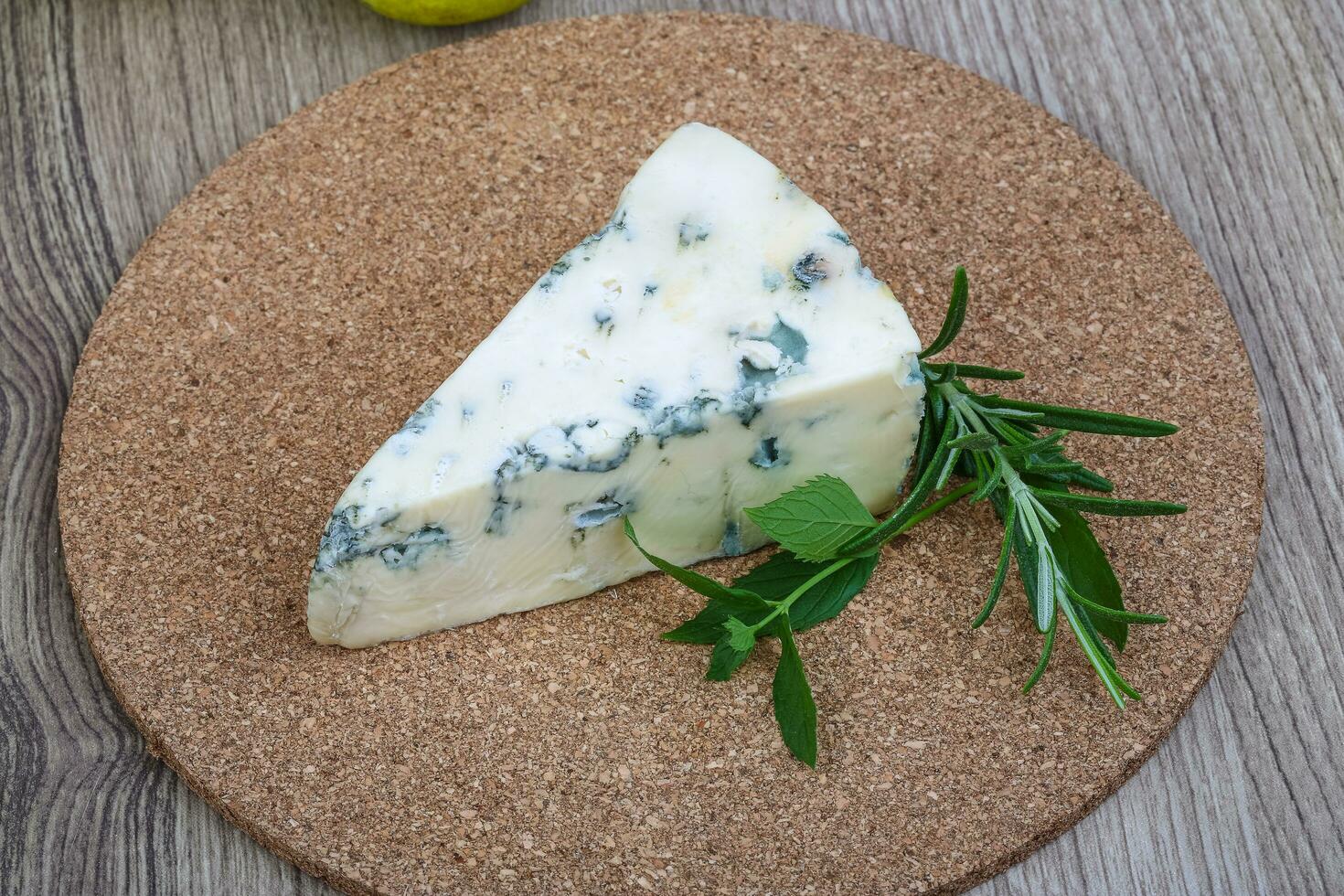 Blue cheese on wooden board and wooden background photo