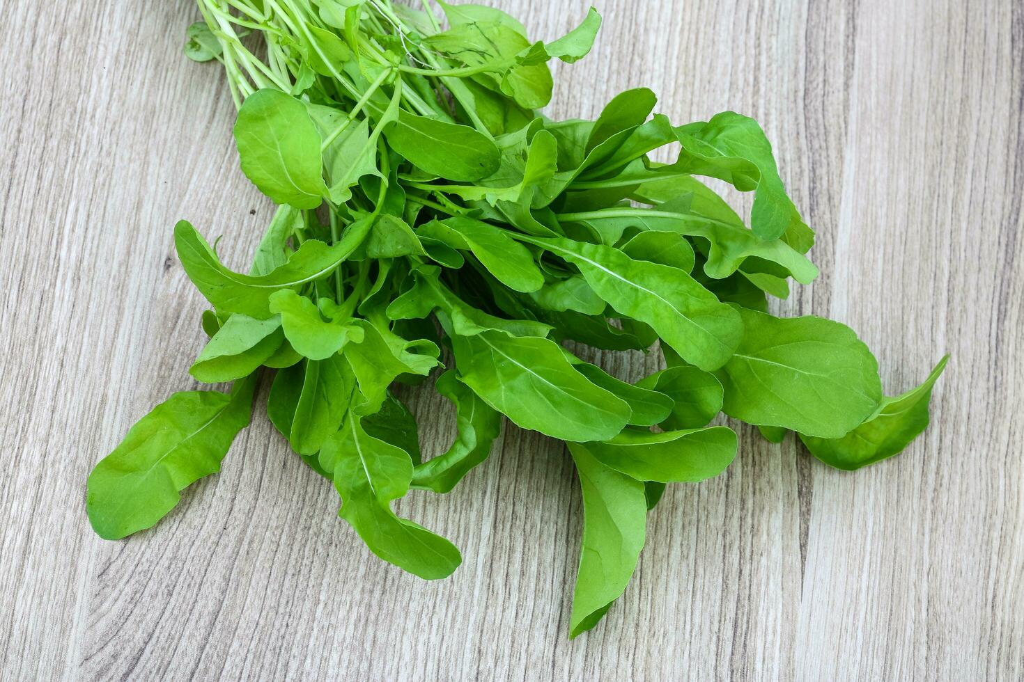 Ruccola on wooden background photo