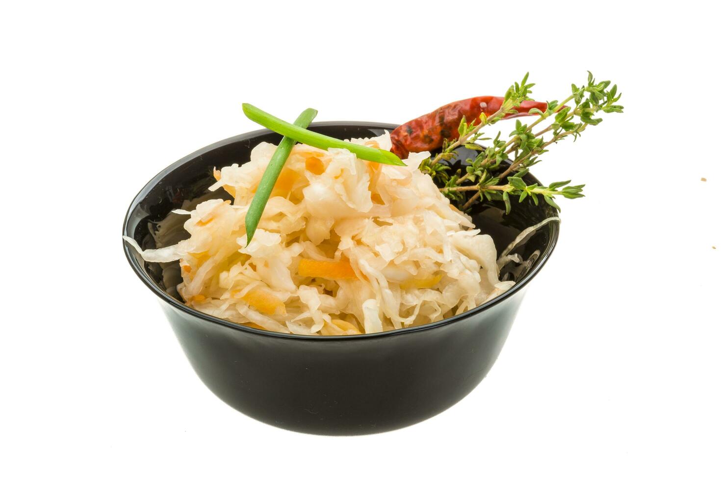 Fermented cabbage in a bowl on white background photo