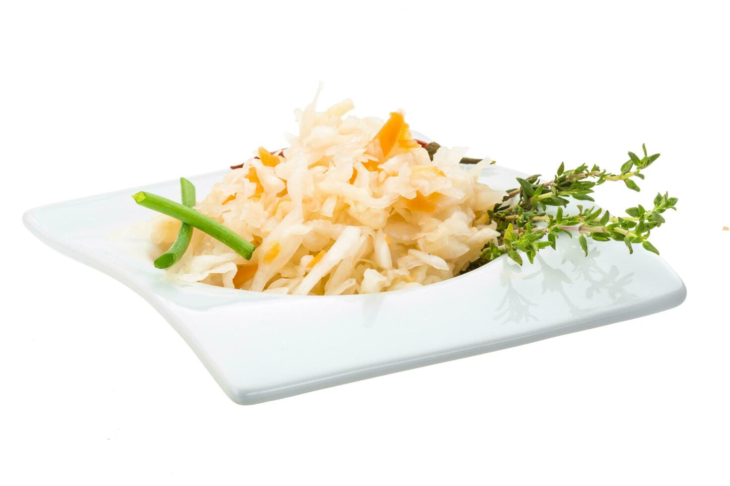 Fermented cabbage in a bowl on white background photo