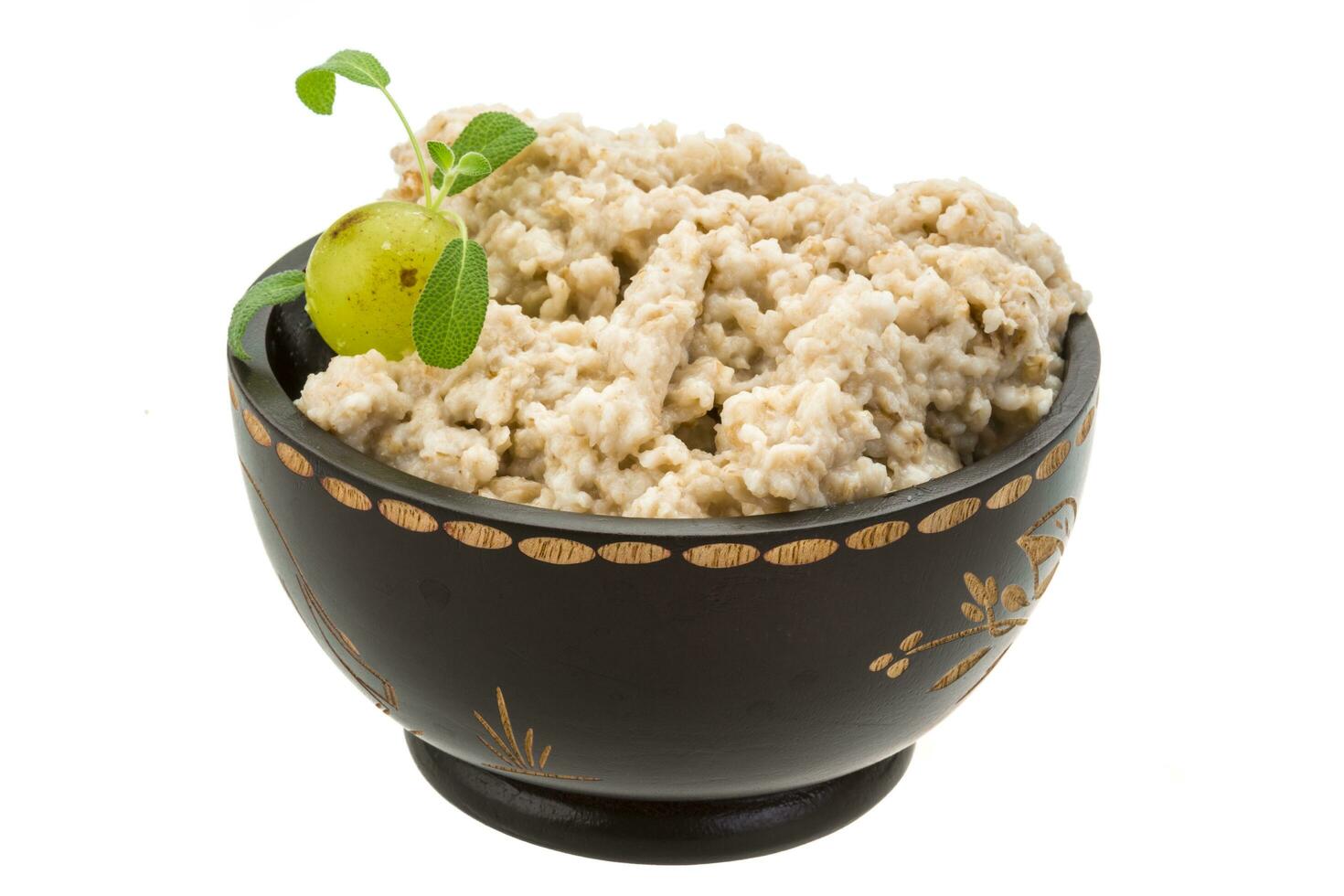 Oats porridge in a bowl on white background photo