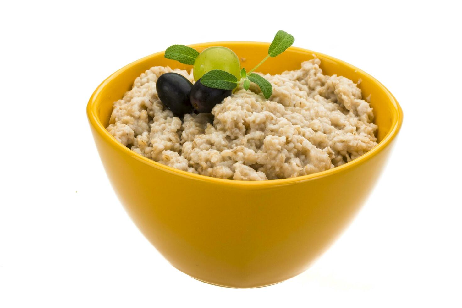 Oats porridge in a bowl on white background photo