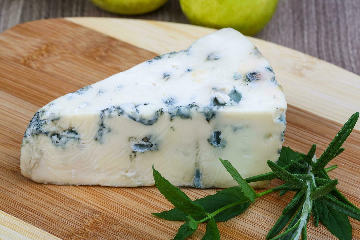 Blue cheese on wooden board and wooden background photo