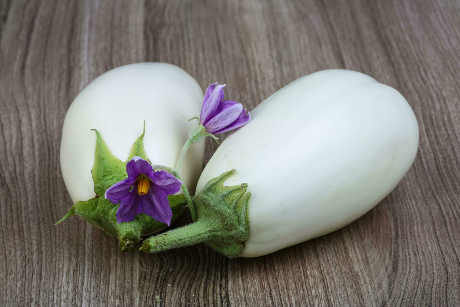 White eggplants on wooden background photo