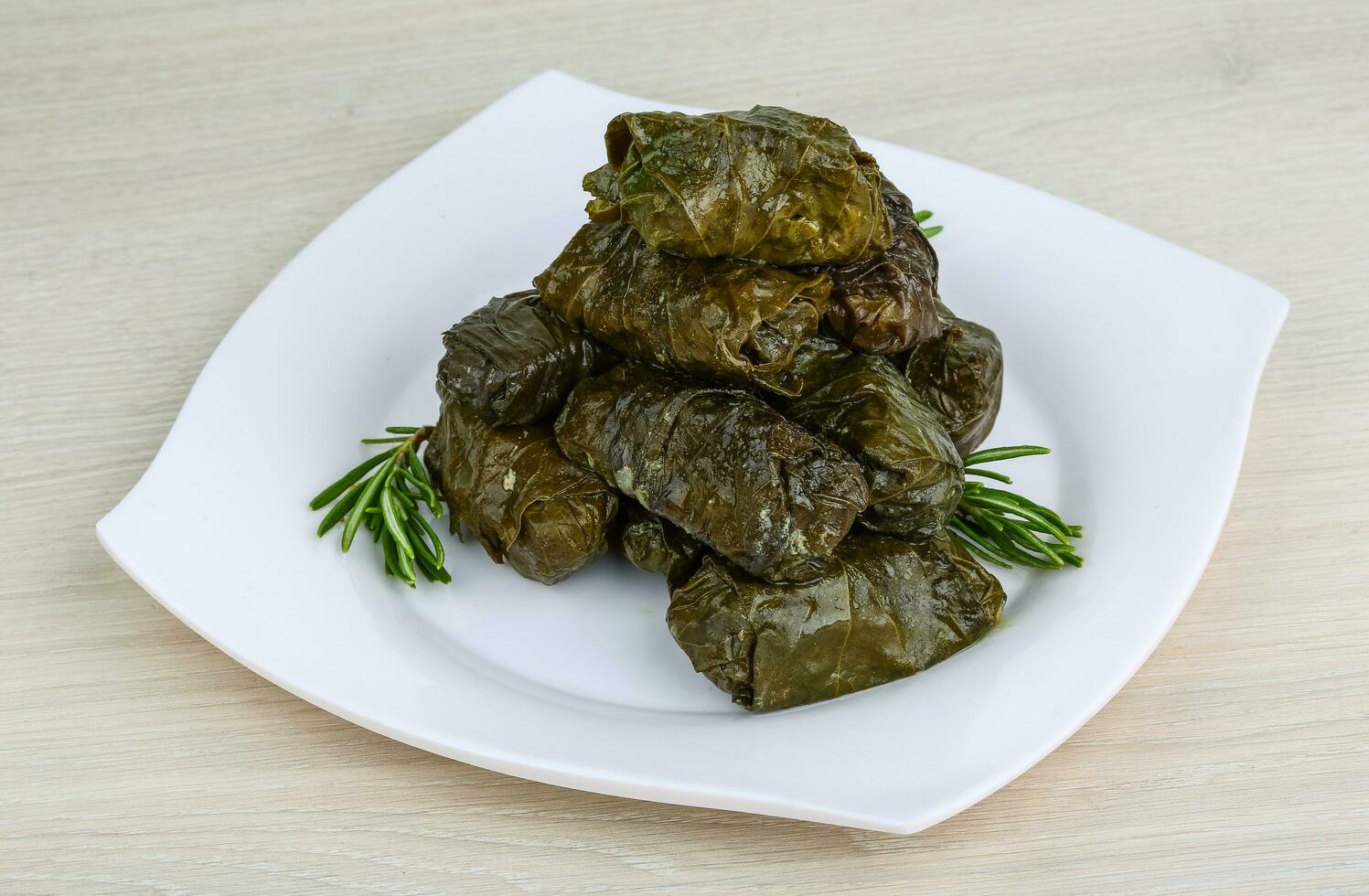 Dolma on the plate and wooden background photo