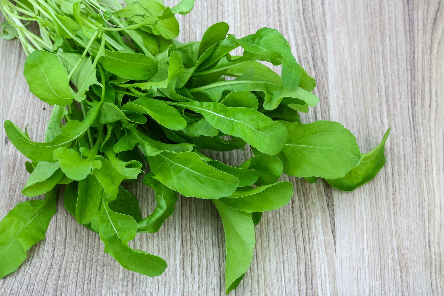 Ruccola on wooden background photo