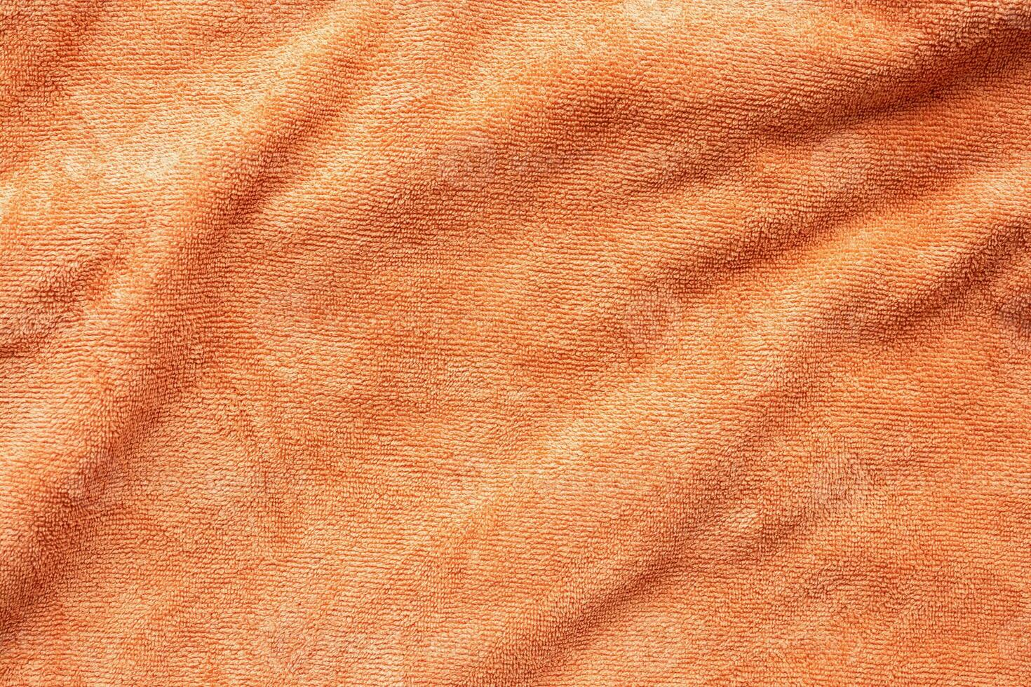 Orange towel fabric texture surface close up background photo