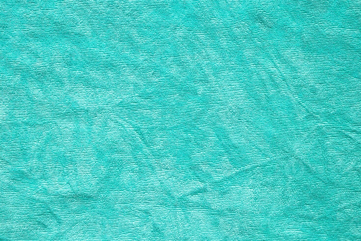 Green towel fabric texture surface close up background photo