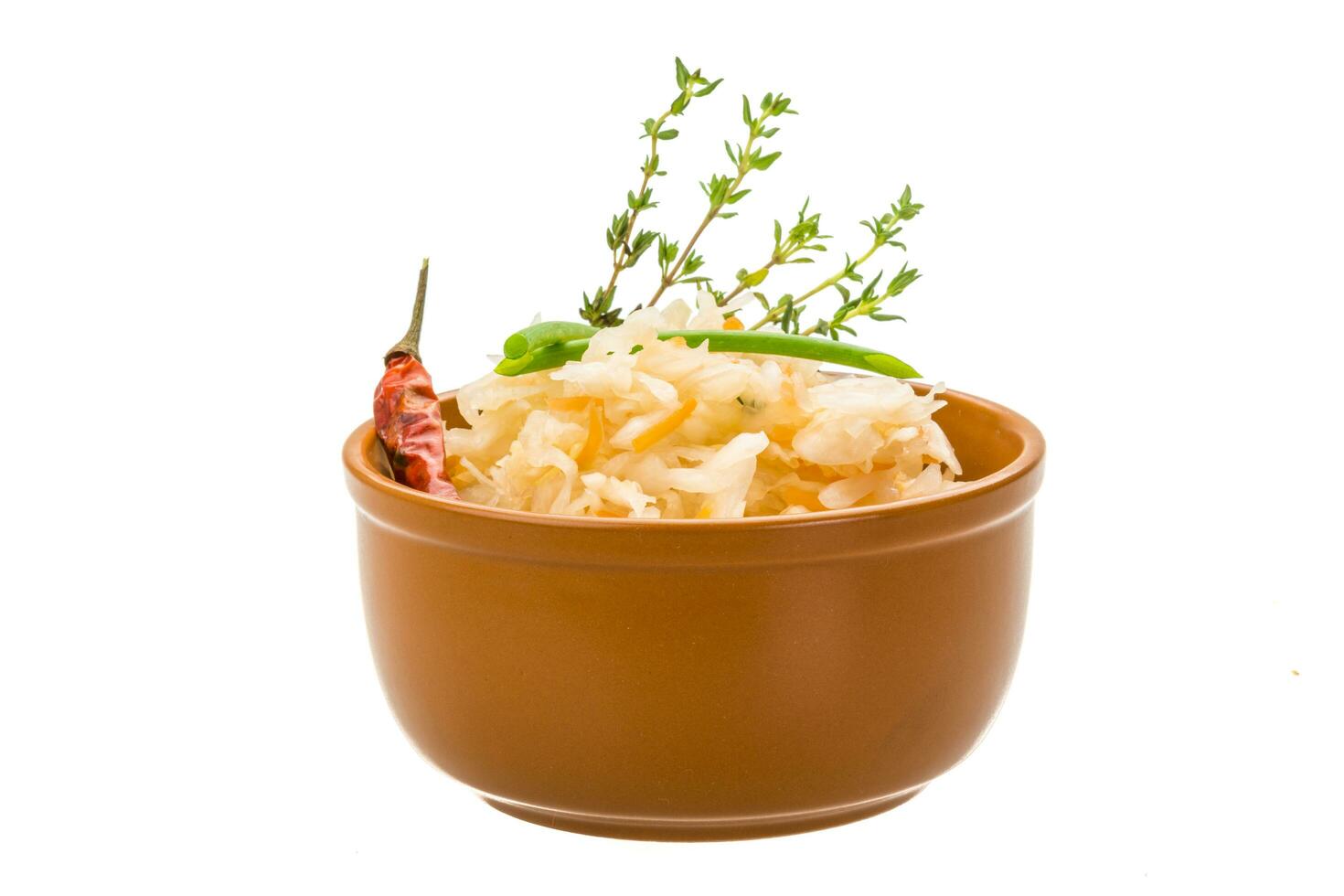 Fermented cabbage in a bowl on white background photo