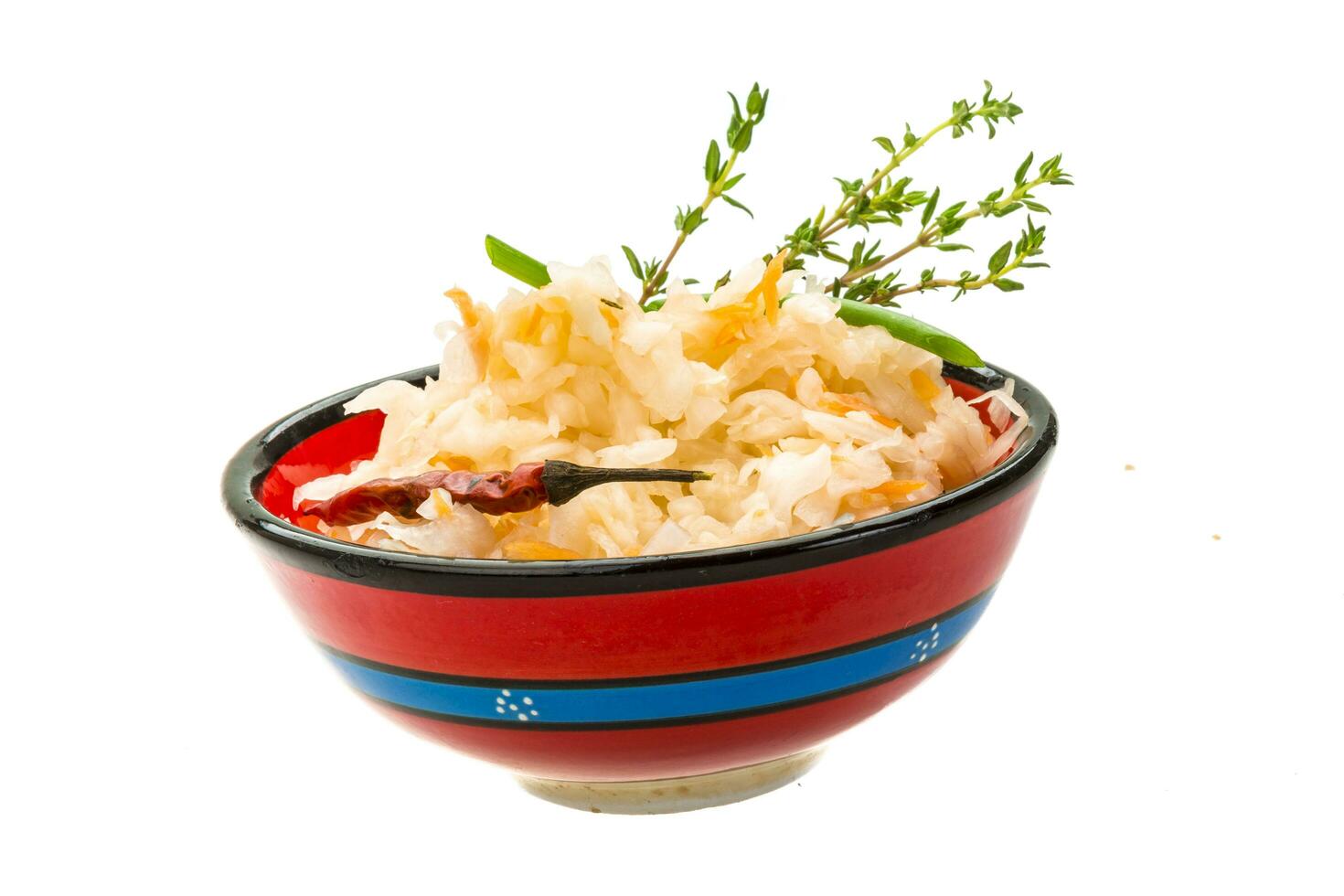 Fermented cabbage in a bowl on white background photo