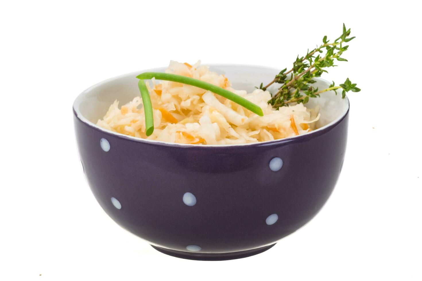 Fermented cabbage in a bowl on white background photo