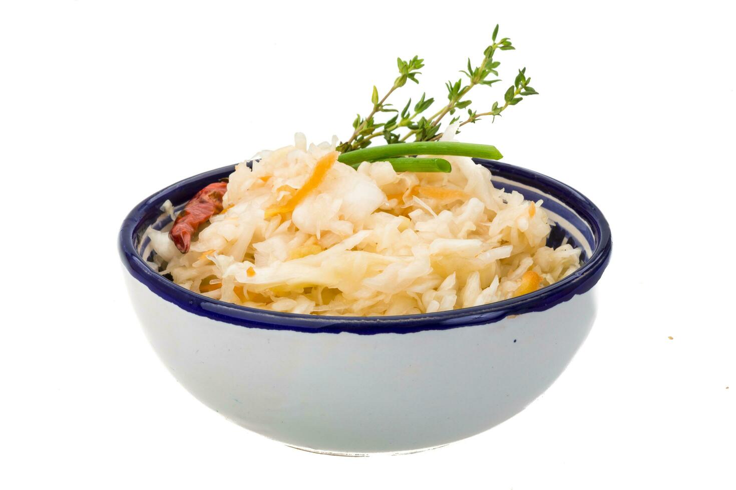 Fermented cabbage in a bowl on white background photo