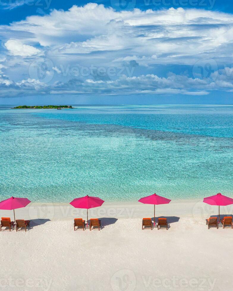 Amazing tranquil sea sand sky. Recreational summer travel tourism. Aerial landscape view with chairs and umbrellas on paradise island beach, seaside. Resort vacation, exotic nature. Beautiful tropics photo
