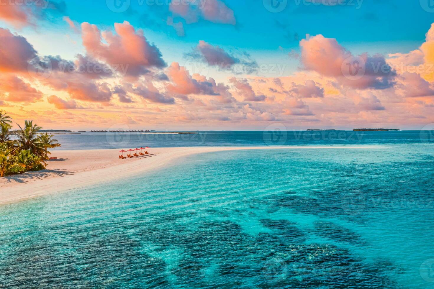 Aerial view of amazing beach, couple umbrellas, chairs beds close to sea lagoon. Fantastic sky clouds summer beach landscape. Idyllic nature for inspire tourism vacation, romantic holiday in Maldives photo