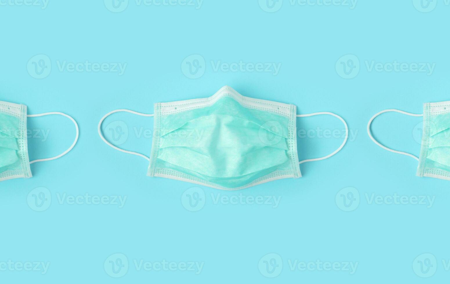 Surgical face mask on blue background protection against COVID-19 coronavirus. Healthcare and medical concept photo