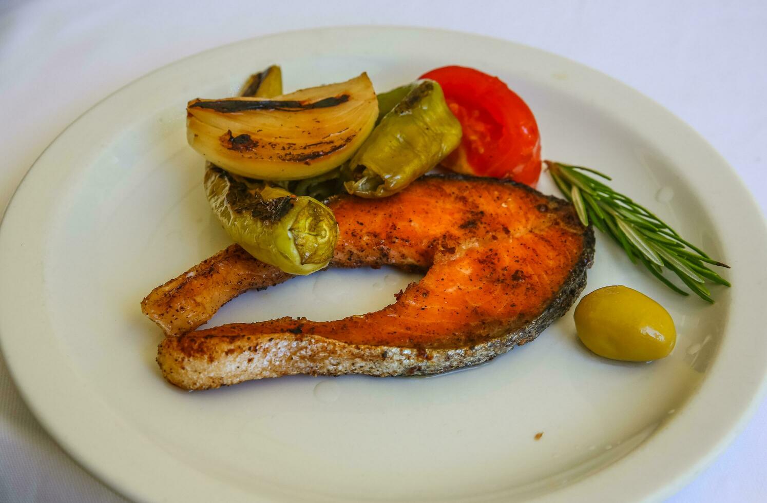 Grilled salmon on the plate and white background photo