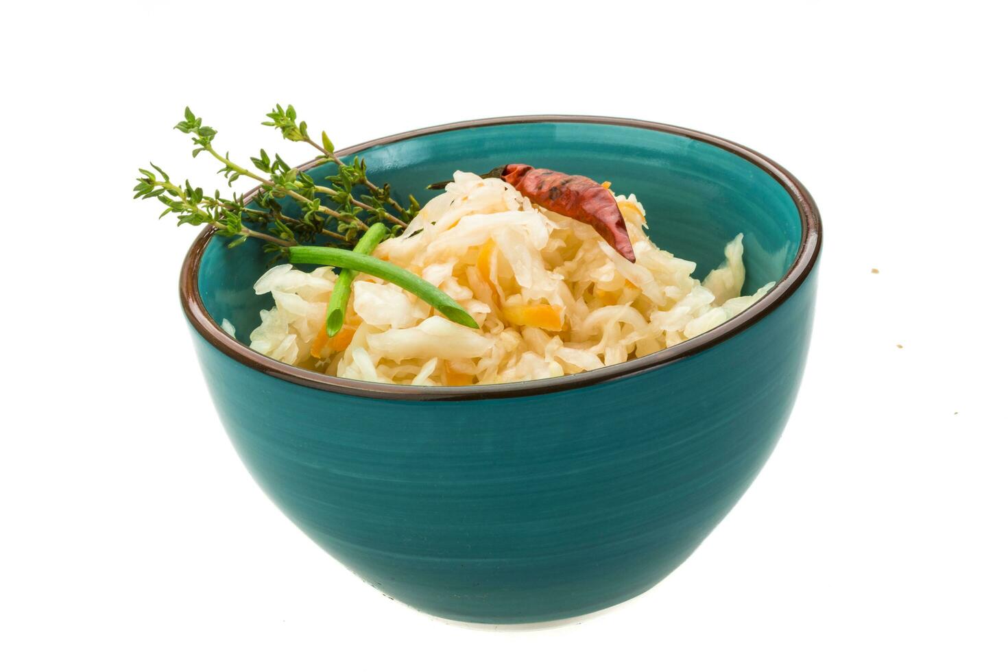 Fermented cabbage in a bowl on white background photo