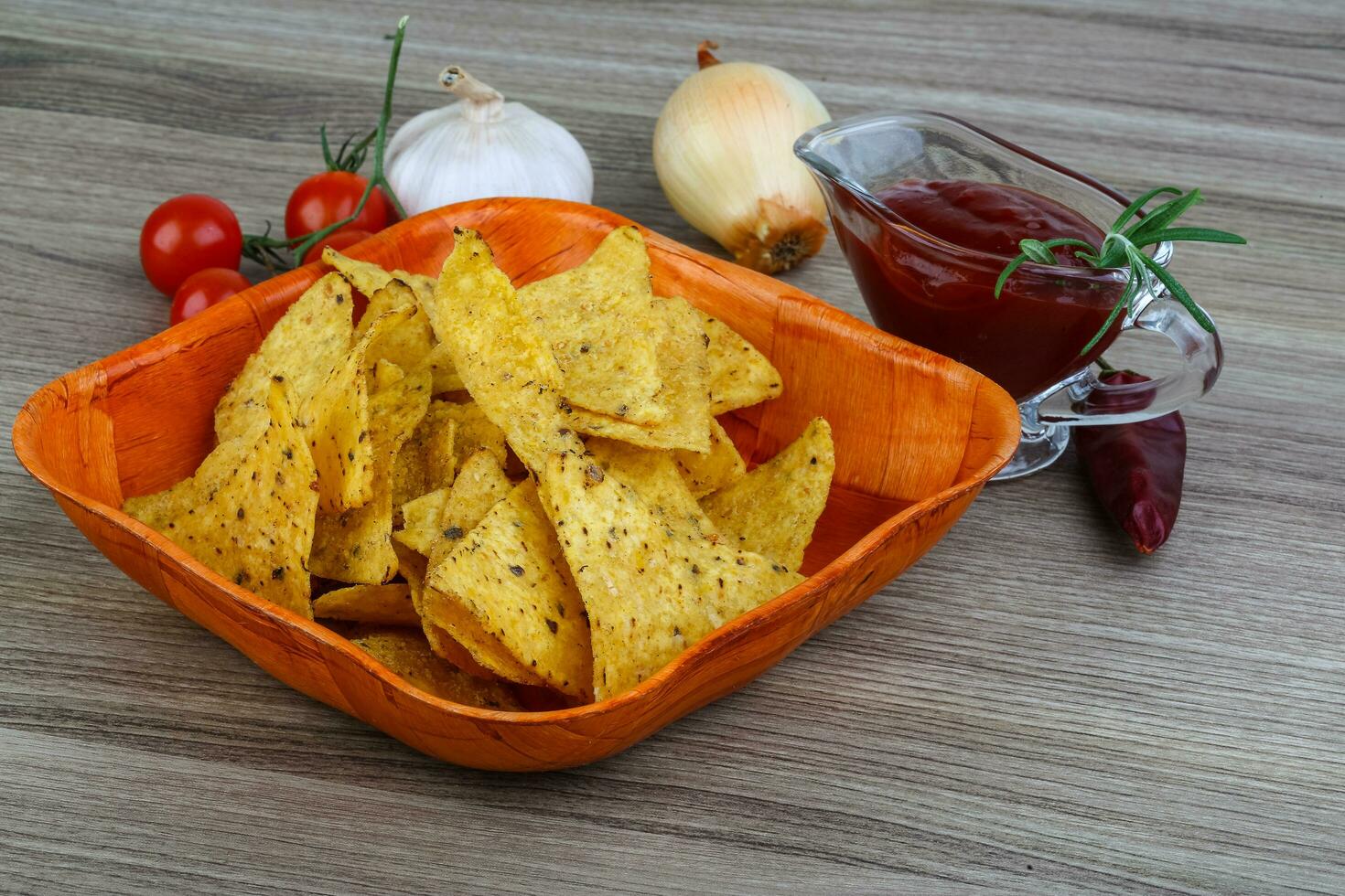 Nachos in a bowl on wooden background photo