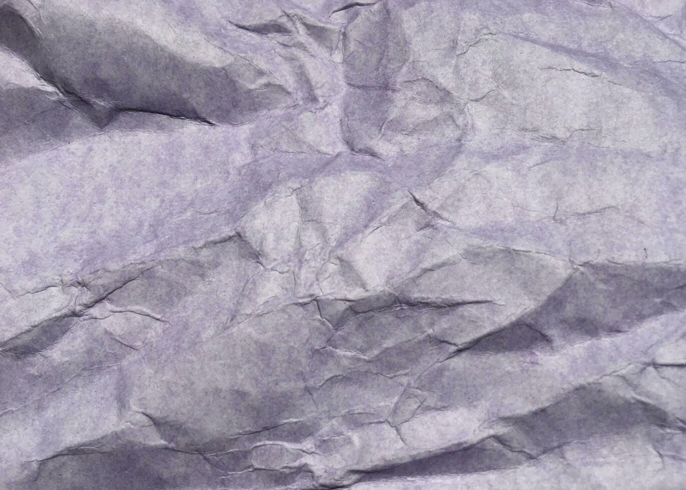 Abstract modern purple crumpled paper texture background. photo