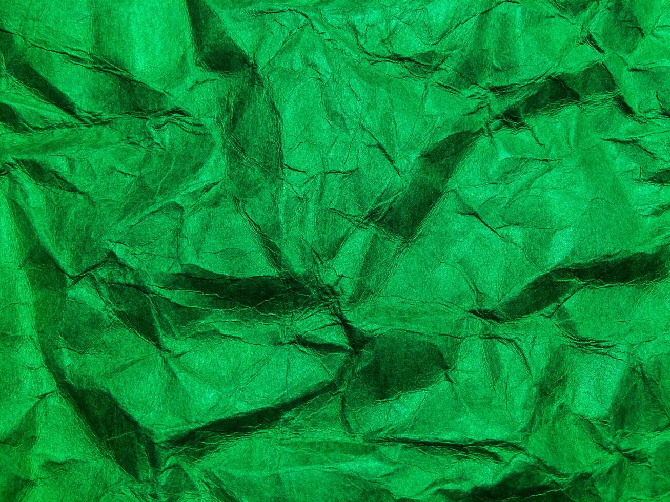 Closeup view of green crumpled paper texture background. photo