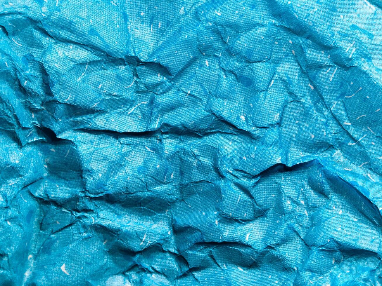 Texture of blue crumpled paper background for design photo