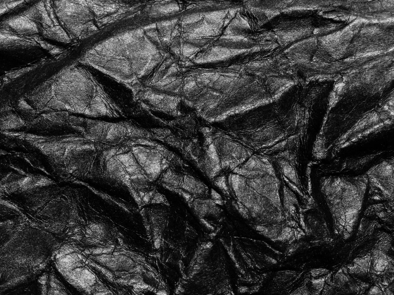 Black crumpled paper texture background. Copy space for design and artwork photo