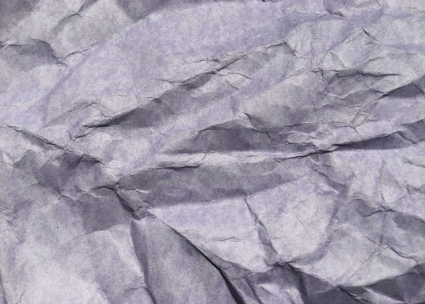 Abstract modern purple crumpled paper texture background. photo