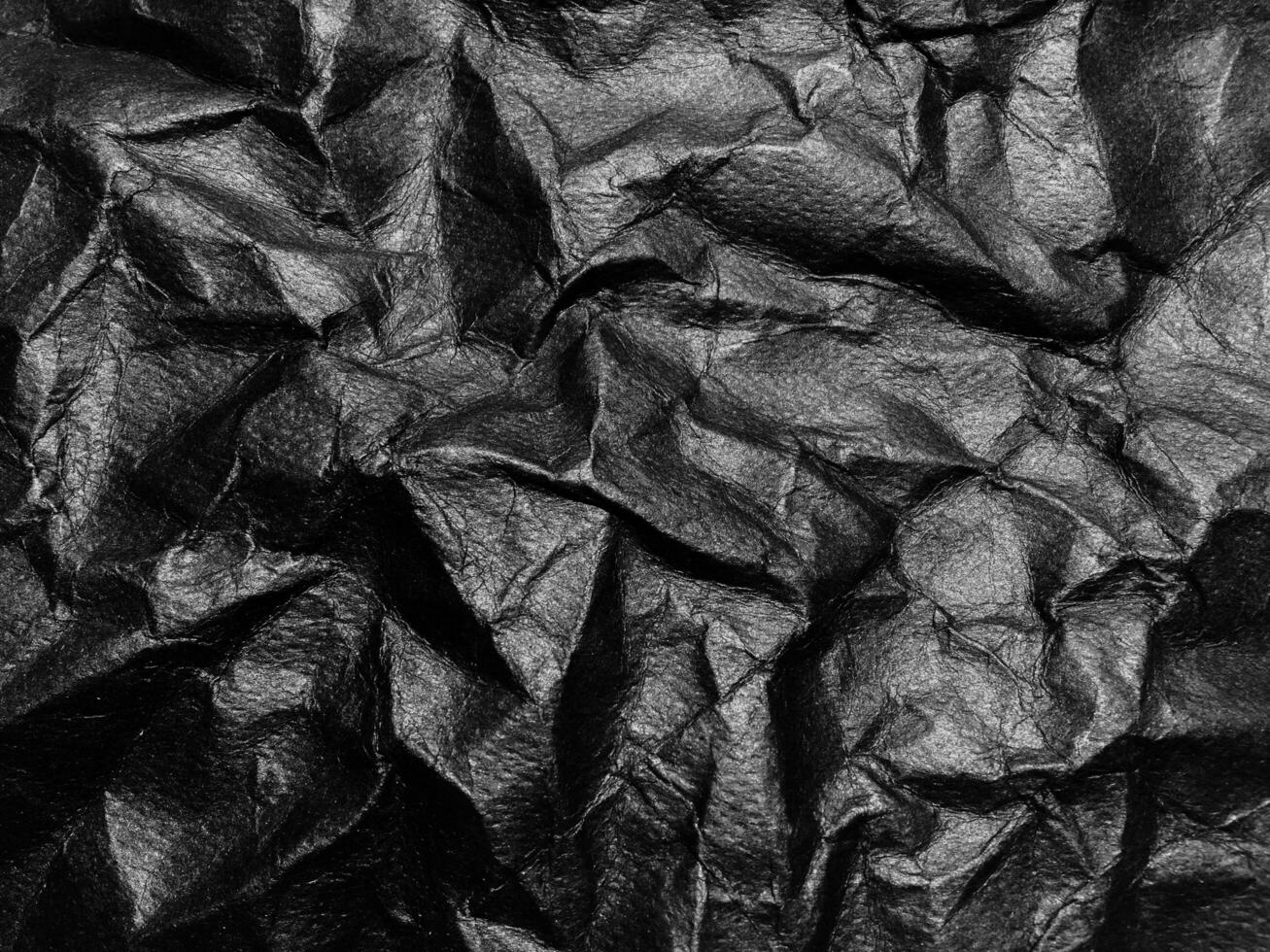 Black crumpled paper texture background. Copy space for design and artwork photo
