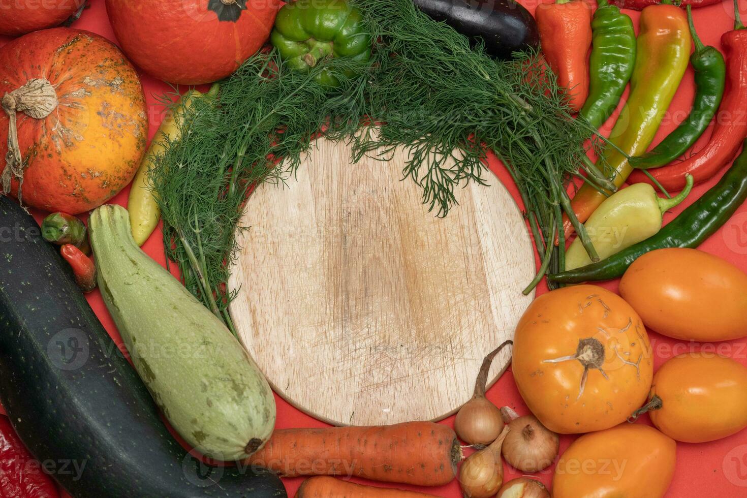 Vegetables are laid out around empty place. Empty space for text. Vegetables on a wooden board. photo