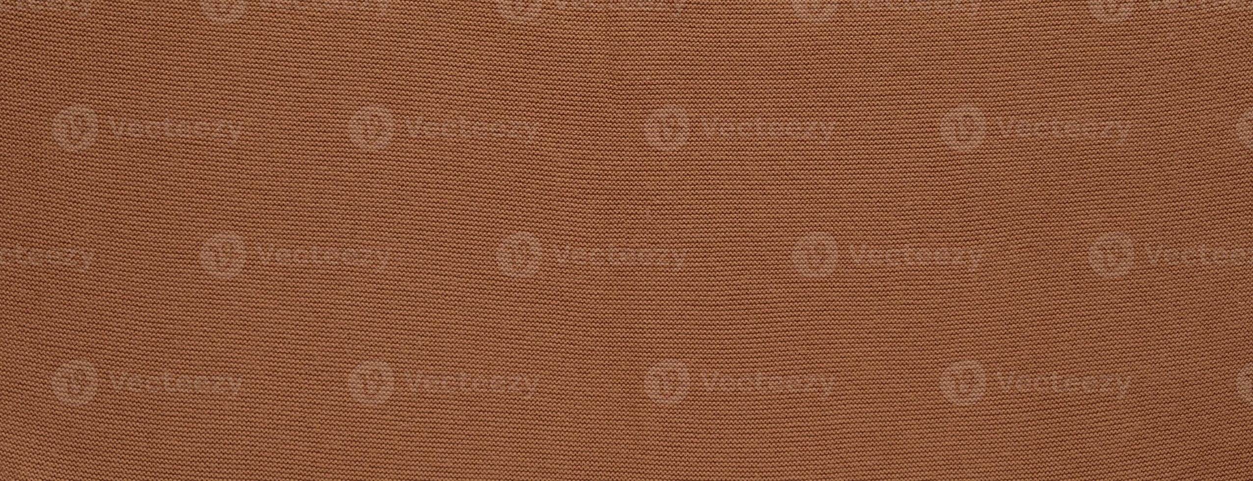Banner with texture of smooth knitted red brown sweater with pattern. Top view, close-up. Handmade knitting wool or cotton fabric texture. Background of knitting patterns. photo