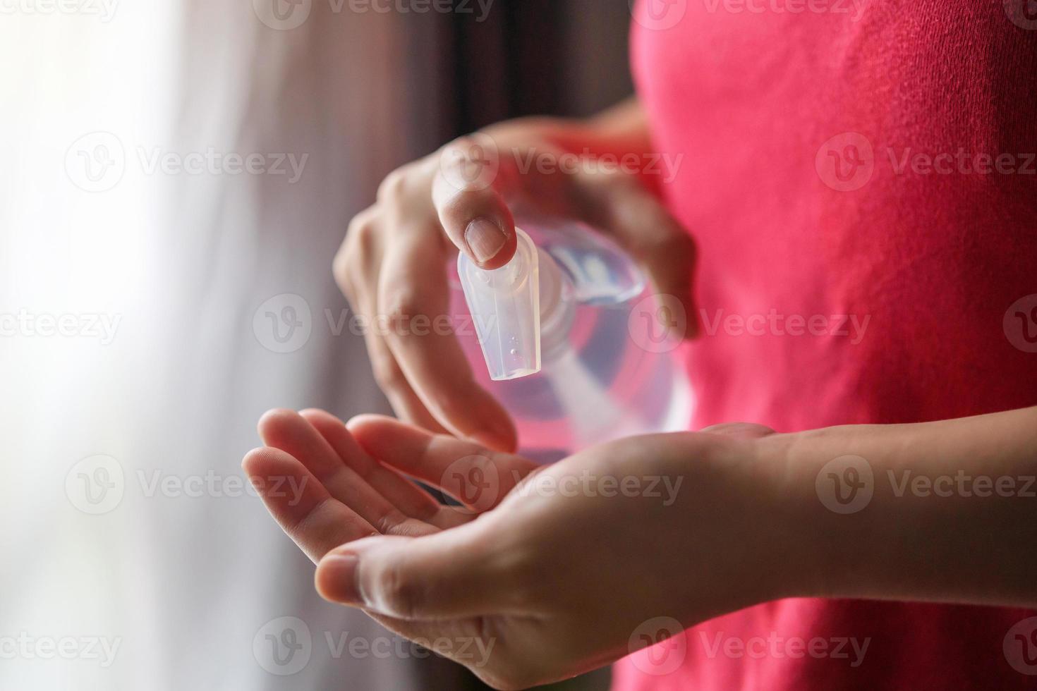 Woman using alcohol sanitizer gel rub for cleaning hand COVID-19 corona virus prevention concept photo