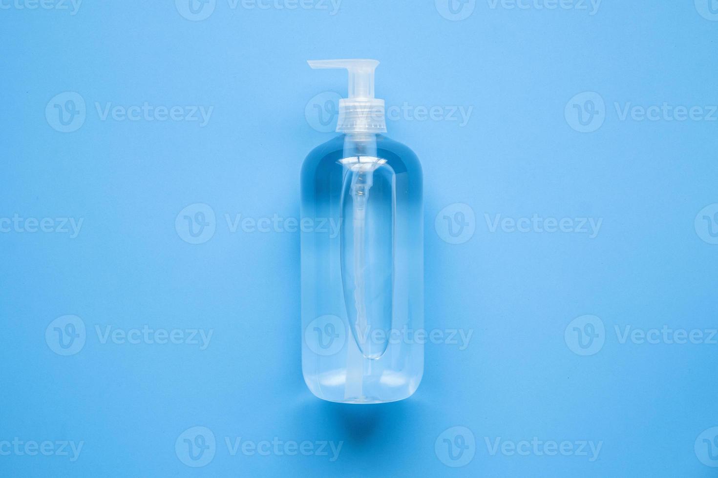 Alcohol hand sanitizer gel bottle on blue background protection against COVID-19 coronavirus. Healthcare and medical concept photo
