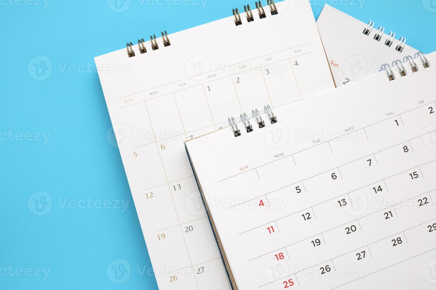 calendar page close up on blue background business planning appointment meeting concept photo