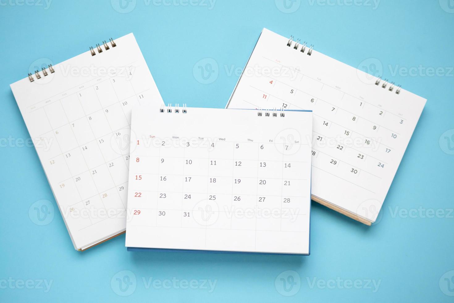 calendar page close up on blue background business planning appointment meeting concept photo